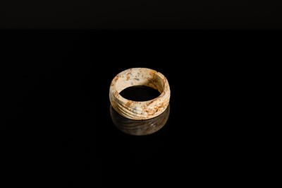 Lot 95 - A YELLOW AND RUSSET JADE ‘ROPE-TWIST’ BANGLE, HAN DYNASTY OR EARLIER