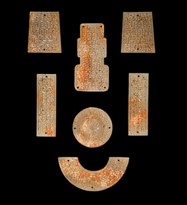 Lot 87 - A SET OF TWELVE WHITE AND RUSSET JADE ORNAMENTS, EASTERN ZHOU DYNASTY
