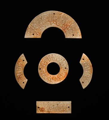 Lot 87 - A SET OF TWELVE WHITE AND RUSSET JADE ORNAMENTS, EASTERN ZHOU DYNASTY