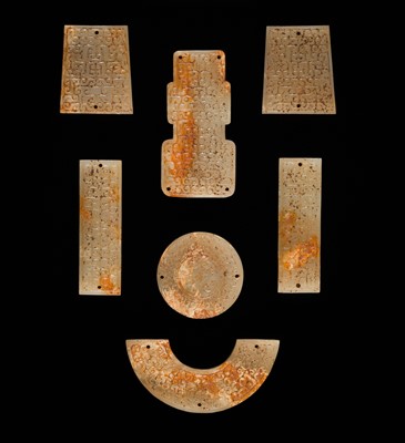 Lot 87 - A SET OF TWELVE WHITE AND RUSSET JADE ORNAMENTS, EASTERN ZHOU DYNASTY