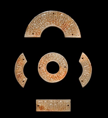 Lot 87 - A SET OF TWELVE WHITE AND RUSSET JADE ORNAMENTS, EASTERN ZHOU DYNASTY