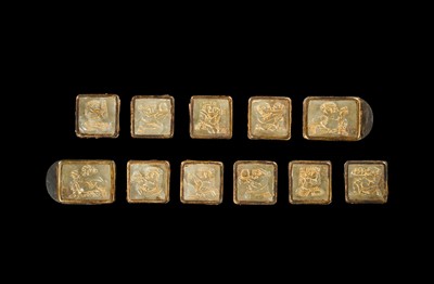 Lot 50 - A SET OF ELEVEN INCISED AND GILT JADE ‘IMMORTAL BANQUET’ BELT PLAQUES WITH GILT SILVER MOUNTS, LIAO DYNASTY