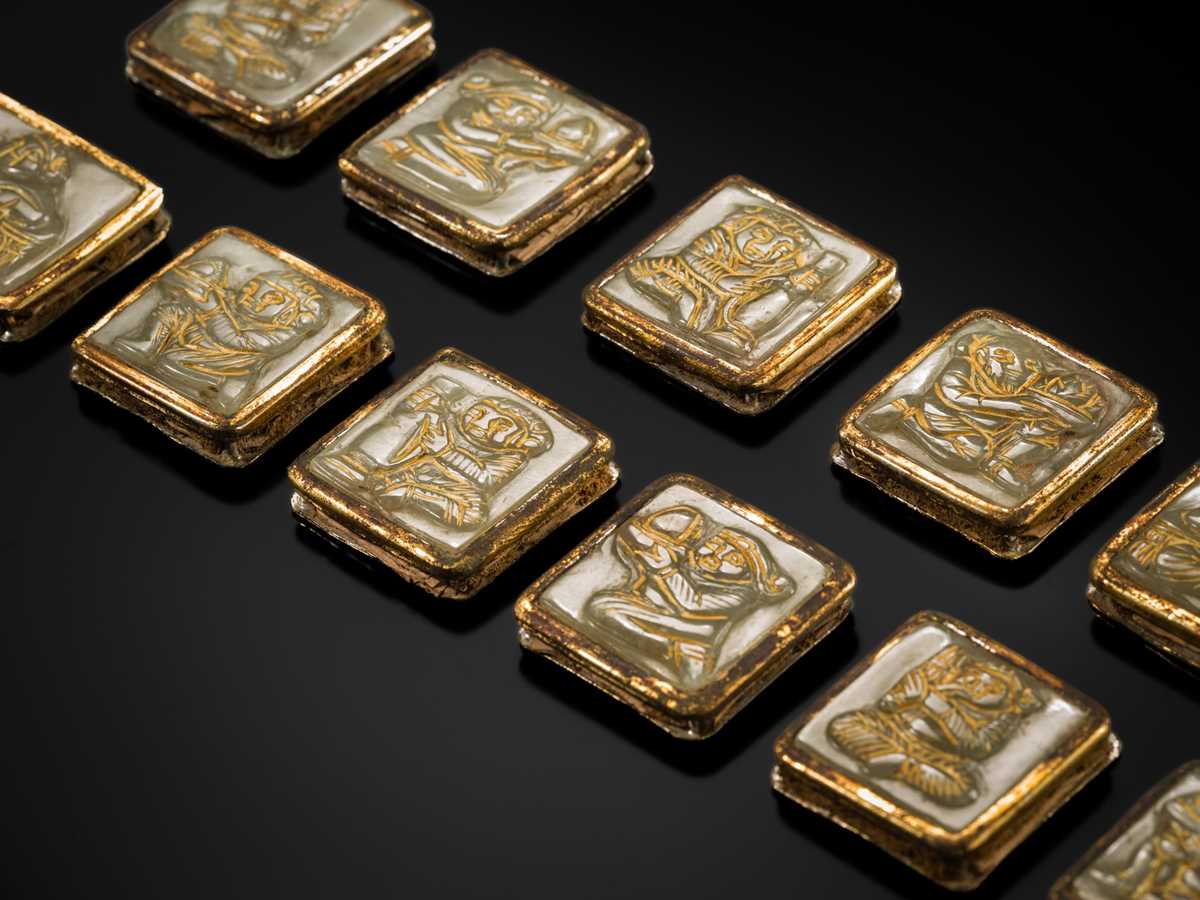 Lot 50 - A SET OF ELEVEN INCISED AND GILT JADE ‘IMMORTAL BANQUET’ BELT PLAQUES WITH GILT SILVER MOUNTS, LIAO DYNASTY