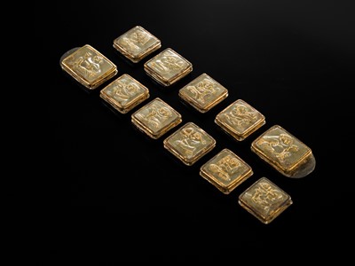 Lot 50 - A SET OF ELEVEN INCISED AND GILT JADE ‘IMMORTAL BANQUET’ BELT PLAQUES WITH GILT SILVER MOUNTS, LIAO DYNASTY