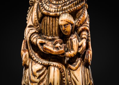 Lot 122 - AN INDO-PORTUGUESE IVORY GROUP DEPICTING SAINT ANNE TEACHING THE VIRGIN TO READ, GOA, LATE 17TH CENTURY