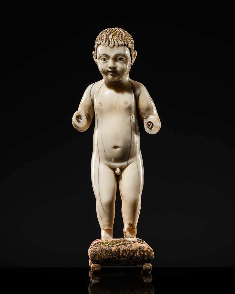 Lot 124 - AN INDO-PORTUGUESE IVORY FIGURE OF THE INFANT CHRIST, GOA, SECOND HALF OF THE 17TH CENTURY