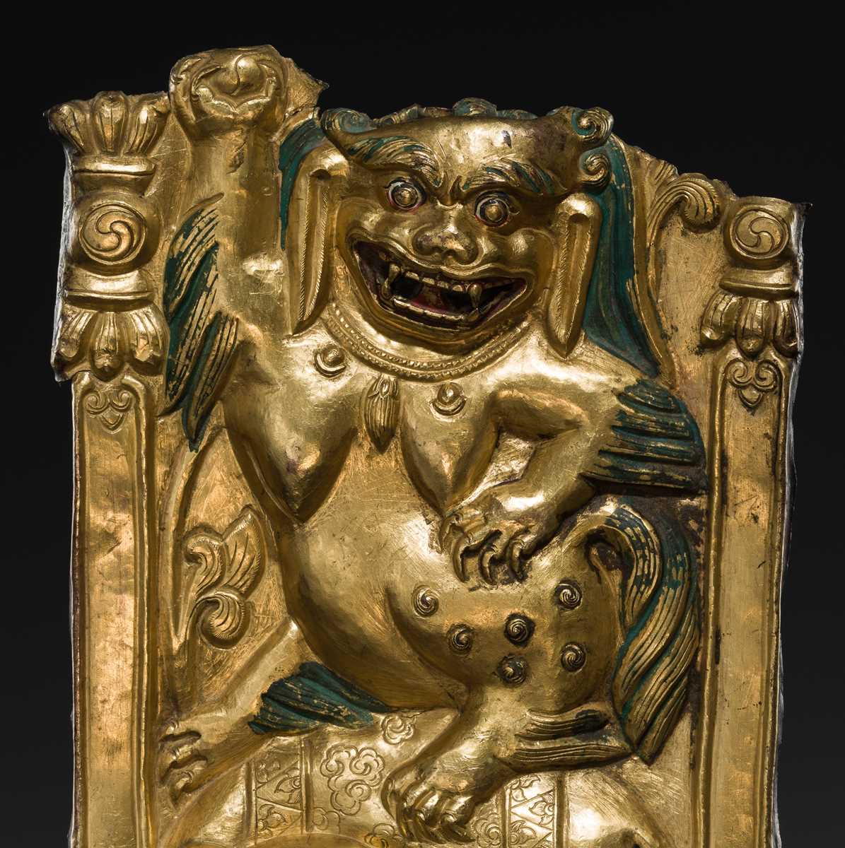 A GILT COPPER REPOUSSÉ ‘LION AND ELEPHANT’ PANEL, TIBET, 17TH-18TH CENTURY