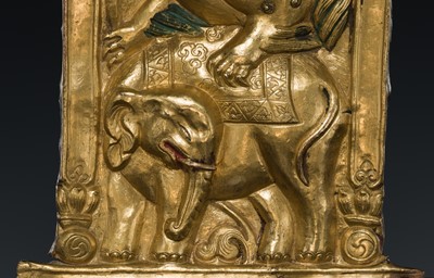 A GILT COPPER REPOUSSÉ ‘LION AND ELEPHANT’ PANEL, TIBET, 17TH-18TH CENTURY