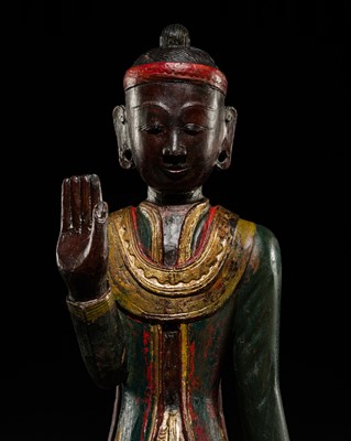 Lot 449 - A LARGE GILT-LACQUERED WOOD FIGURE OF A STANDING BUDDHA, BURMA, 18TH-19TH CENTURY