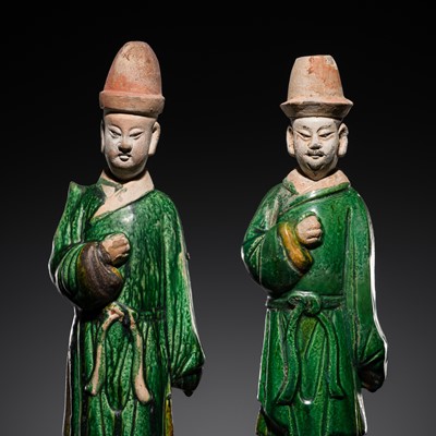 Lot 245 - A PAIR OF SANCAI-GLAZED POTTERY FIGURES OF ATTENDANTS, MING DYNASTY
