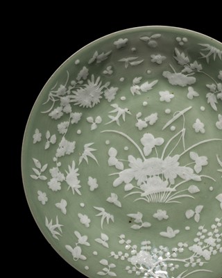 Lot 260 - A CELADON-GROUND SLIP-DECORATED DISH, QING DYNASTY