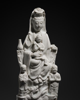 Lot 273 - A DEHUA FIGURE OF GUANYIN WITH A CHILD AND ACOLYTES, c. 1920s