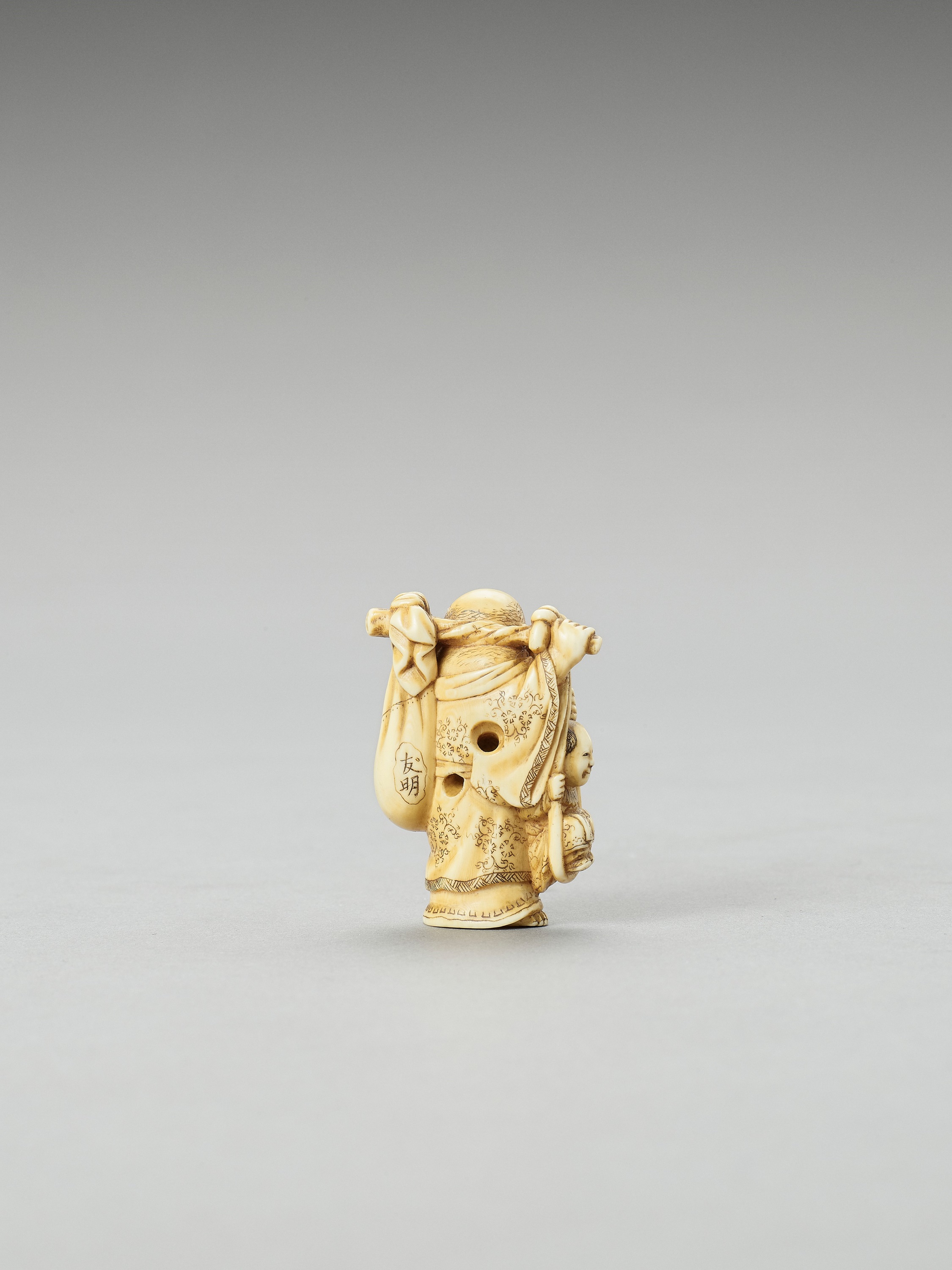 Lot 208 - TOMOAKI: AN IVORY NETSUKE OF HOTEI CARRYING