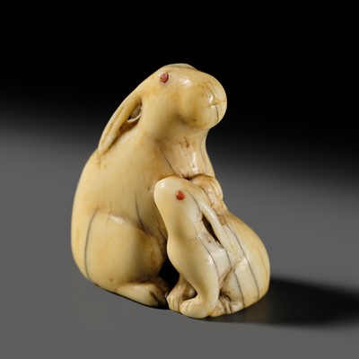 Lot 119 - TADAMITSU: A FINE IVORY NETSUKE OF TWO HARES