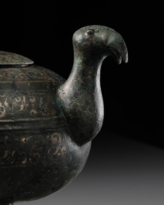 Lot 90 - A SILVER-INLAID BRONZE ‘BIRD’ WINE VESSEL AND COVER, WARRING STATES PERIOD