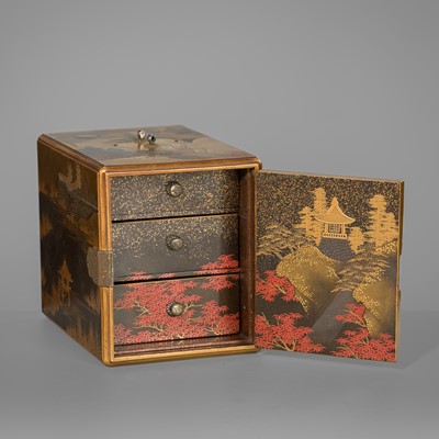 Lot 97 - A GOLD AND BLACK LACQUER KODANSU (SMALL CABINET) WITH LANDSCAPE SCENES