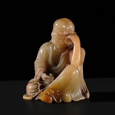 Lot 134 - A FINELY CARVED ‘FURONG’ SOAPSTONE FIGURE OF AN EMACIATED LUOHAN, 17TH-18TH CENTURY