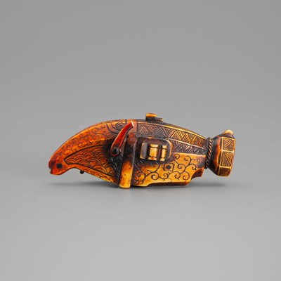 Lot 611 - AN UNUSUAL IVORY NETSUKE OF A PISTOL