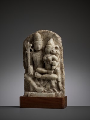 Lot 742 - AN INDIAN WHITE MARBLE RELIEF OF UMA MAHESHVARA, 12TH-13TH CENTURY