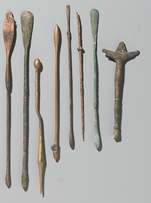 Lot 173 - A GROUP OF TWENTY-FOUR GREEK AND ROMAN BRONZE PINS, SPOONS AND TOOLS, 1ST MILLENNIUM AD AND EARLIER