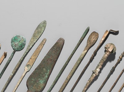 Lot 173 - A GROUP OF TWENTY-FOUR GREEK AND ROMAN BRONZE PINS, SPOONS AND TOOLS, 1ST MILLENNIUM AD AND EARLIER