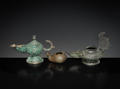 Lot 158 - A GROUP OF THREE BRONZE OIL LAMPS