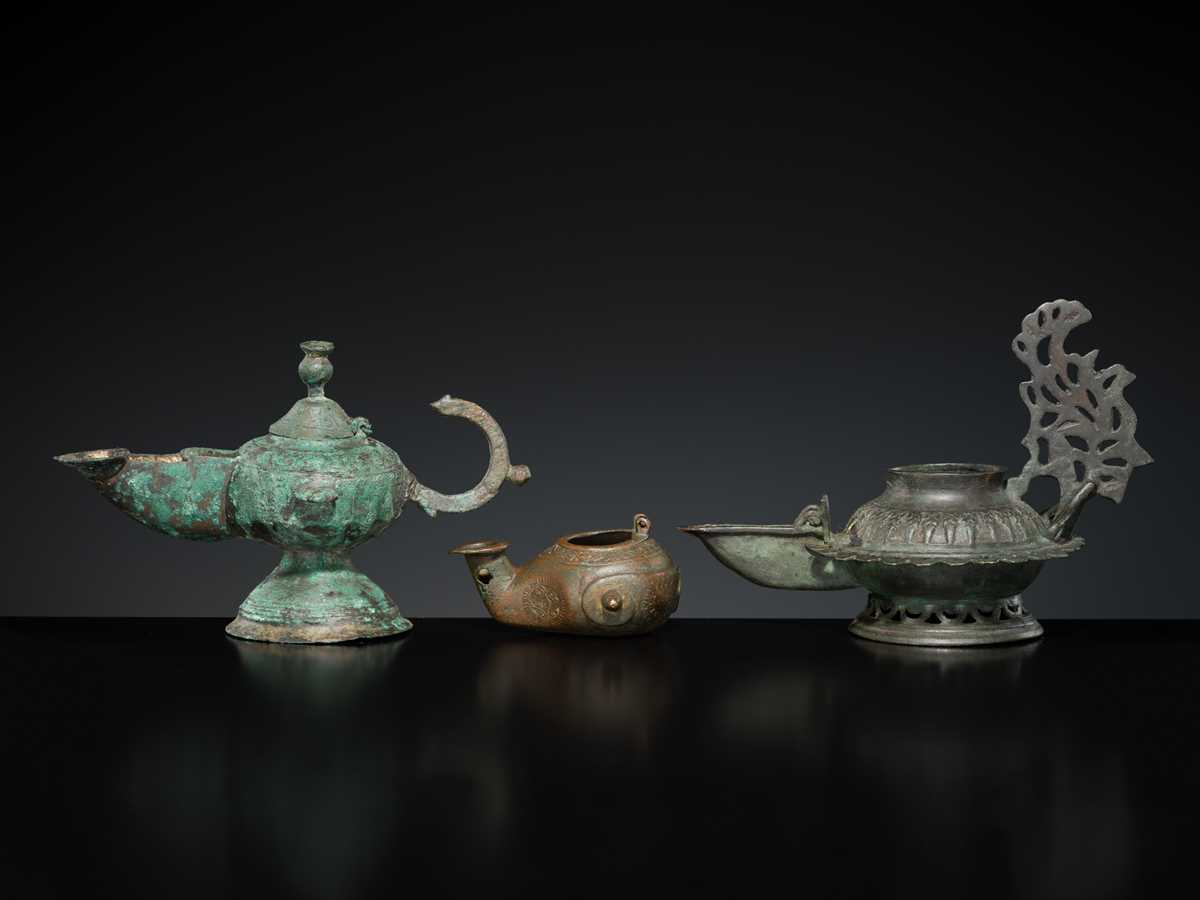 Lot 158 - A GROUP OF THREE BRONZE OIL LAMPS