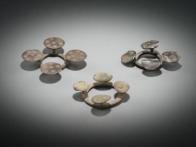 Lot 176 - A GROUP OF THREE BRONZE QUATREFOIL FIBULAS OR STRAP FITTINGS