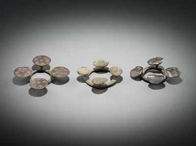 Lot 176 - A GROUP OF THREE BRONZE QUATREFOIL FIBULAS OR STRAP FITTINGS