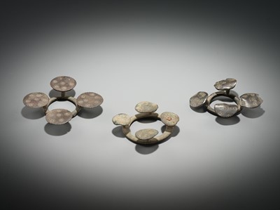 Lot 176 - A GROUP OF THREE BRONZE QUATREFOIL FIBULAS OR STRAP FITTINGS