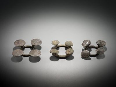 Lot 176 - A GROUP OF THREE BRONZE QUATREFOIL FIBULAS OR STRAP FITTINGS