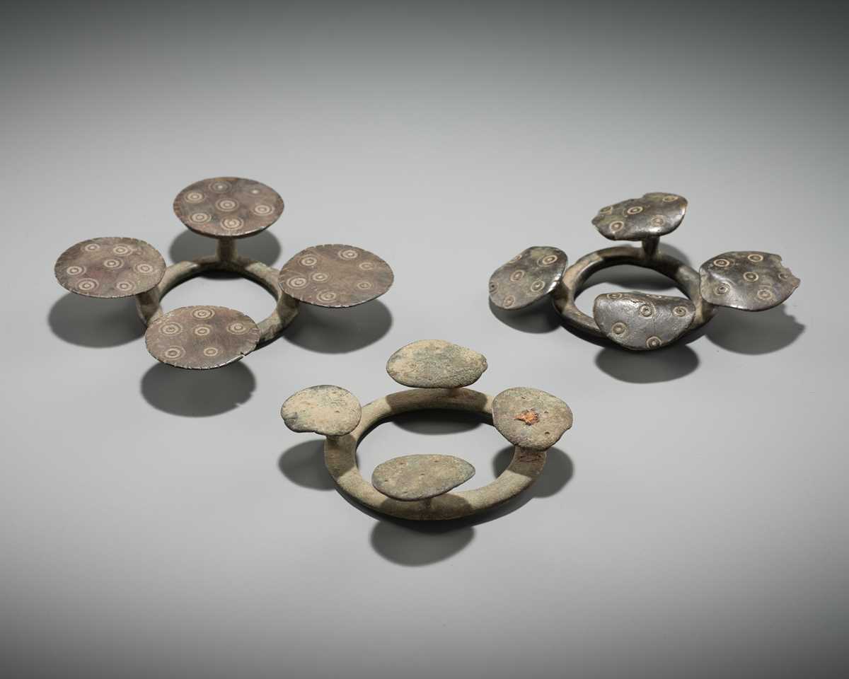 Lot 176 - A GROUP OF THREE BRONZE QUATREFOIL FIBULAS OR STRAP FITTINGS