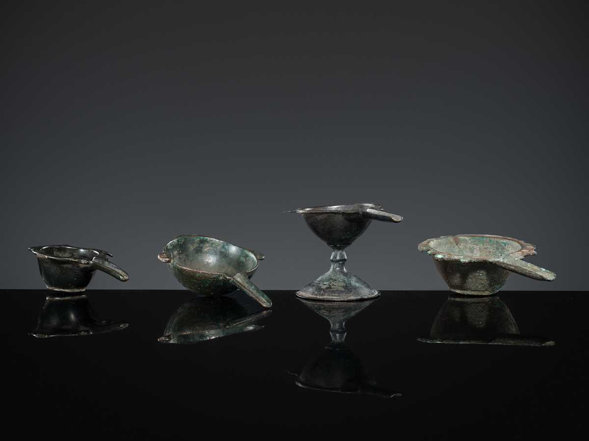 Lot 167 - A GROUP OF FOUR EARLY ISLAMIC BRONZE COSMETIC MORTARS, CIRCA 7TH-12TH CENTURY