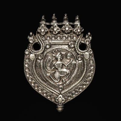 Lot 204 - A GROUP OF SIX SILVER REPOUSSÉ AMULET PENDANTS AND VOTIVE PLAQUE, HIMACHAL PRADESH AND RAJASTHAN
