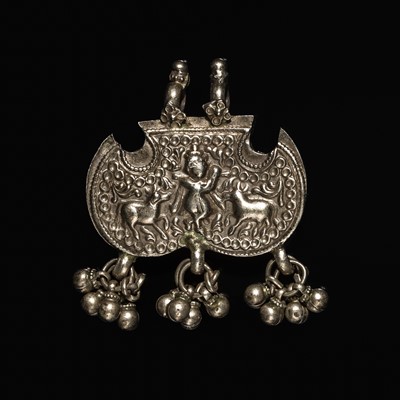 Lot 204 - A GROUP OF SIX SILVER REPOUSSÉ AMULET PENDANTS AND VOTIVE PLAQUE, HIMACHAL PRADESH AND RAJASTHAN