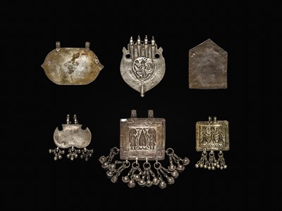 Lot 204 - A GROUP OF SIX SILVER REPOUSSÉ AMULET PENDANTS AND VOTIVE PLAQUE, HIMACHAL PRADESH AND RAJASTHAN