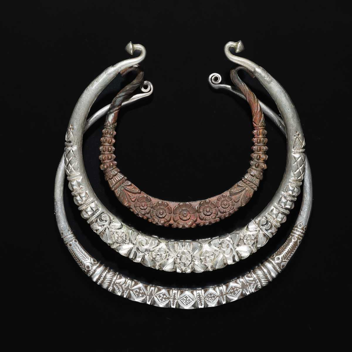 Lot 200 - A GROUP OF ONE COPPER AND TWO SILVER NECK TORQUES, 19TH-20TH CENTURY