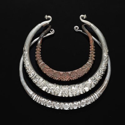Lot 200 - A GROUP OF ONE COPPER AND TWO SILVER NECK TORQUES, 19TH-20TH CENTURY
