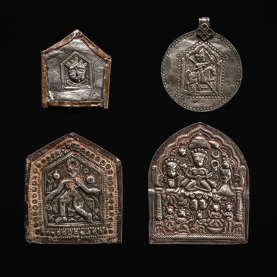 Lot 109 - A GROUP OF THREE SILVER REPOUSSÉ VOTIVE PLAQUES AND A PILGRIMAGE AND DEVOTIONAL PENDANT, PHUL, MAHARASHTRA, 19TH CENTURY OR EARLIER