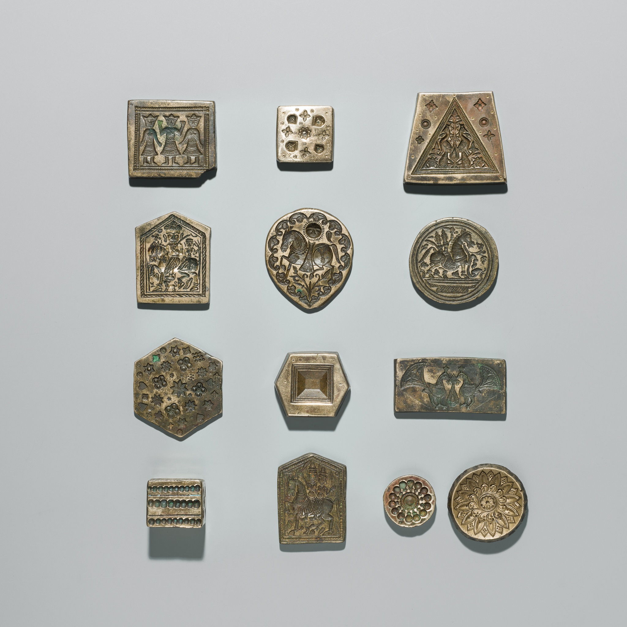 Lot 218 - A GROUP OF THIRTEEN BRASS MOLDS, INDIA, 20TH