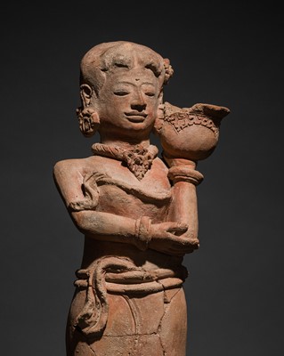 Lot 288 - A MAJAPAHIT TERRACOTTA FIGURE OF A GIRL CARRYING A BOWL