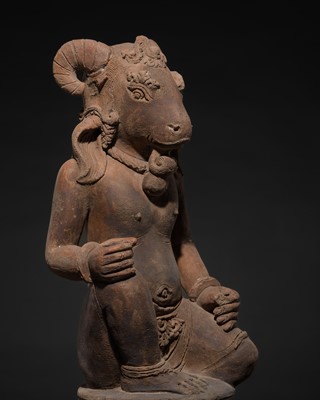 Lot 213 - A MAJAPAHIT TERRACOTTA FIGURE OF A DEITY WITH RAM HEAD