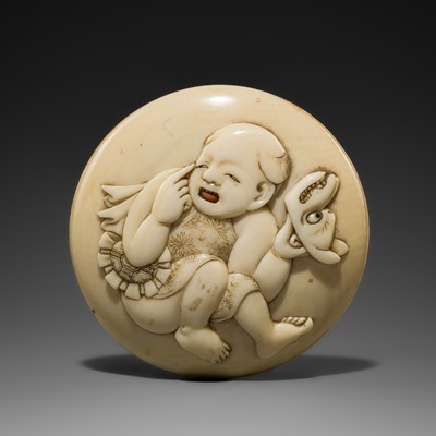 KIKUGAWA: AN INLAID IVORY MANJU NETSUKE DEPICTING A KARAKO WITH A KITSUNE MASK
