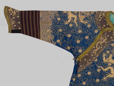 Lot 104 - AN IMPERIAL GOLD- AND SILVER-EMBROIDERED ‘NINE DRAGON’ ROBE, JIFU, QIANLONG