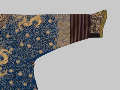 Lot 104 - AN IMPERIAL GOLD- AND SILVER-EMBROIDERED ‘NINE DRAGON’ ROBE, JIFU, QIANLONG
