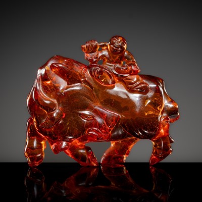 Lot 420 - A CARVED AMBER ‘OX AND HERDER’ GROUP, QING DYNASTY