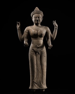 Lot 259 - A RARE AND LARGE SANDSTONE FIGURE OF A FOUR-ARMED GODDESS, ANGKOR PERIOD