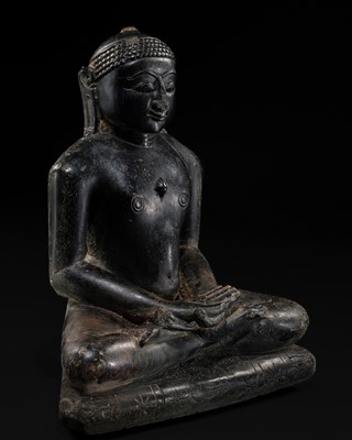 Lot 354 - A JAIN BLACK STONE FIGURE OF A TIRTHANKARA, WESTERN INDIA, CIRCA 17TH-18TH CENTURY OR EARLIER