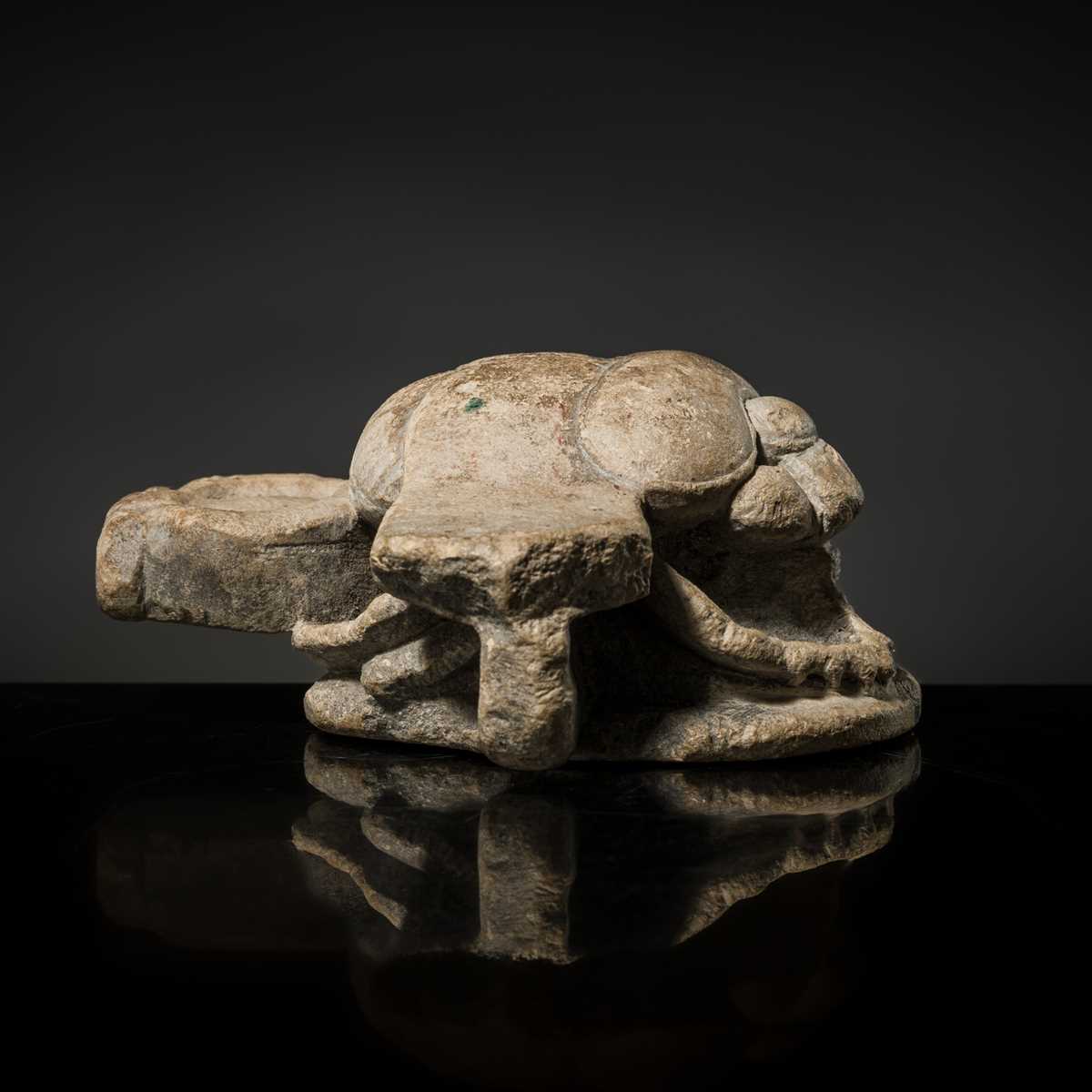 Lot 32 - AN INDURATED LIMESTONE FIGURE OF A WINGED SCARAB, KHEPRI, MIDDLE KINGDOM TO LATE PERIOD