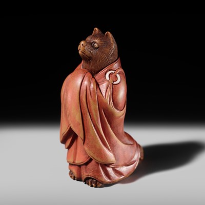 Lot 153 - IKKO: A FINE AND AMUSING WOOD NETSUKE OF TANUKI DISGUISED AS A PRIEST